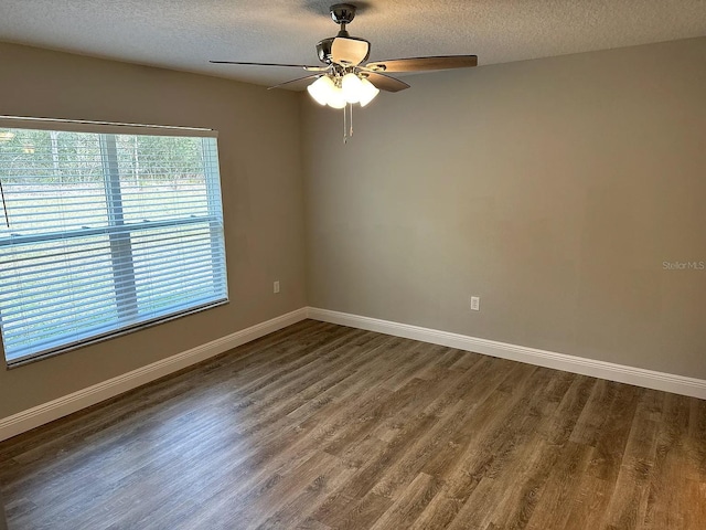 9252 N Agatha Dr, Citrus Springs, FL 34434 - spare room with dark wood finished floors, a textured ceiling, ceiling fan, and baseboards