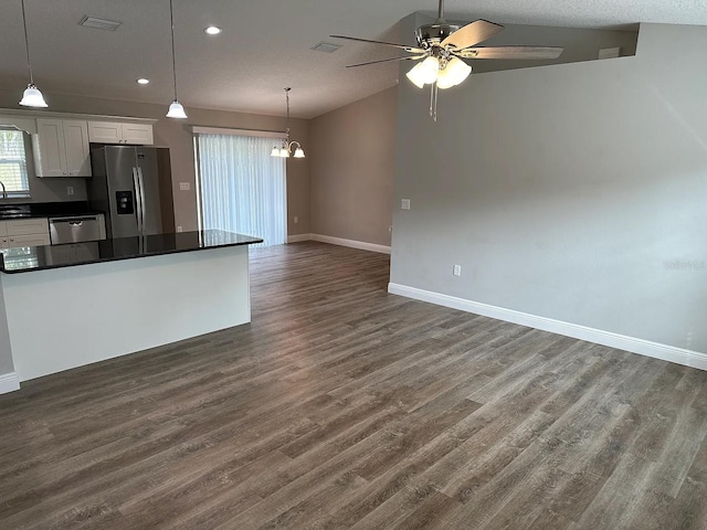 9252 N Agatha Dr, Citrus Springs, FL 34434 - kitchen featuring appliances with stainless steel finishes, dark countertops, open floor plan, ceiling fan, and white cabinets