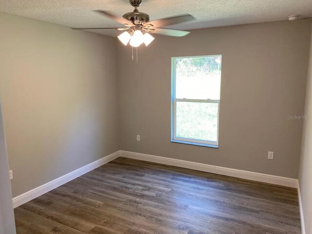 9252 N Agatha Dr, Citrus Springs, FL 34434 - spare room with dark wood-style floors, ceiling fan, a textured ceiling, and baseboards