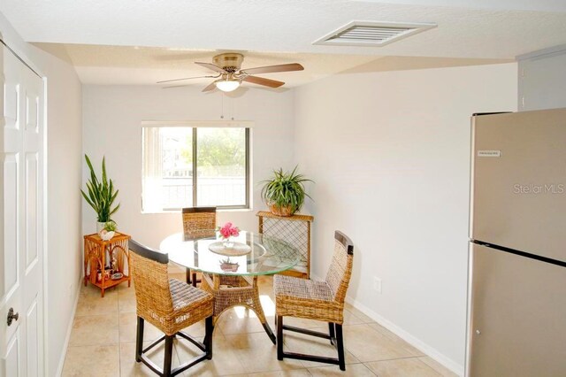 dining area with a ceiling fan, light tile patterned floors, and baseboards