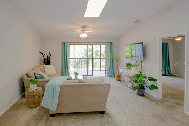 carpeted living room featuring a ceiling fan, baseboards, and a skylight