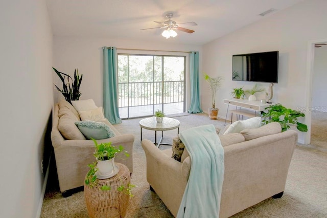 living area with carpet floors, lofted ceiling, and a ceiling fan