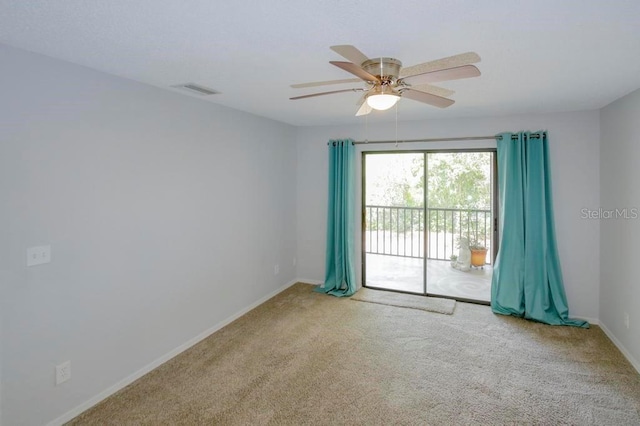 carpeted empty room with baseboards and ceiling fan
