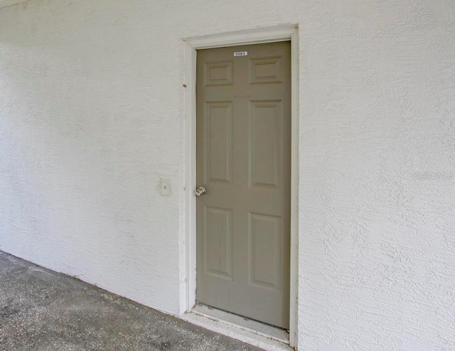 doorway to property with stucco siding
