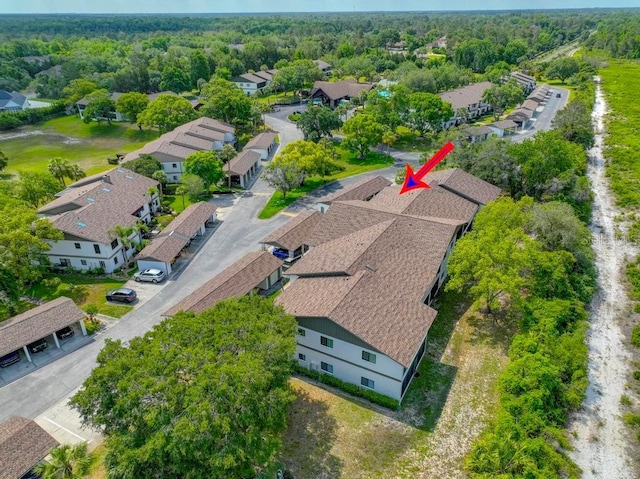 aerial perspective of suburban area featuring a forest