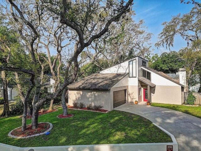 10910 Winter Oak Pl, Tampa, FL 33618 - view of front of property with a garage, driveway, stucco siding, and a chimney