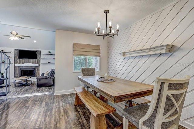10910 Winter Oak Pl, Tampa, FL 33618 - dining room with a fireplace, dark wood-style floors, ceiling fan, a chandelier, and baseboards