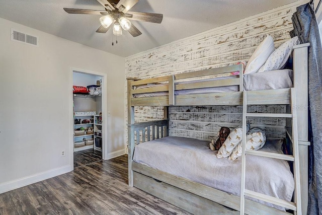 10910 Winter Oak Pl, Tampa, FL 33618 - bedroom with a walk in closet, baseboards, wood finished floors, a closet, and a ceiling fan