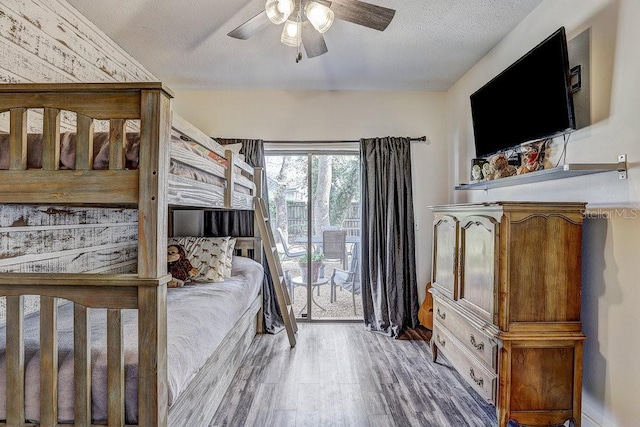 10910 Winter Oak Pl, Tampa, FL 33618 - bedroom featuring access to exterior, wood finished floors, a ceiling fan, and a textured ceiling