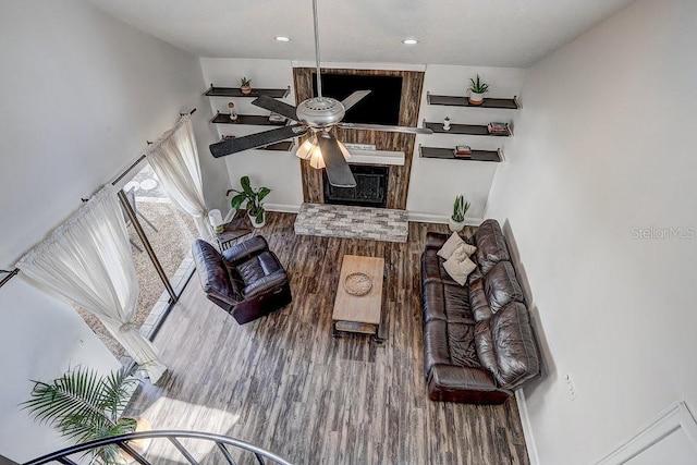 10910 Winter Oak Pl, Tampa, FL 33618 - living area with wood finished floors, ceiling fan, baseboards, a fireplace, and recessed lighting