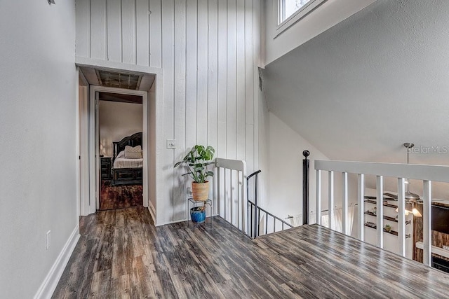 10910 Winter Oak Pl, Tampa, FL 33618 - hall with an upstairs landing, wood finished floors, baseboards, wooden walls, and high vaulted ceiling