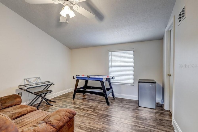 10910 Winter Oak Pl, Tampa, FL 33618 - recreation room featuring dark wood-style floors, a ceiling fan, baseboards, and a textured ceiling