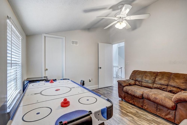 10910 Winter Oak Pl, Tampa, FL 33618 - rec room with vaulted ceiling, wood finished floors, a ceiling fan, plenty of natural light, and baseboards