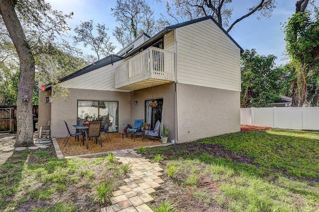 10910 Winter Oak Pl, Tampa, FL 33618 - rear view of house featuring a balcony, fence, stucco siding, and a patio area
