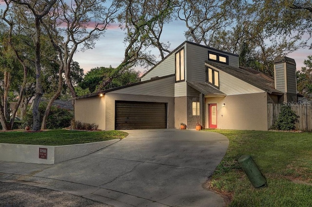 10910 Winter Oak Pl, Tampa, FL 33618 - mid-century modern home featuring concrete driveway, an attached garage, a chimney, and stucco siding