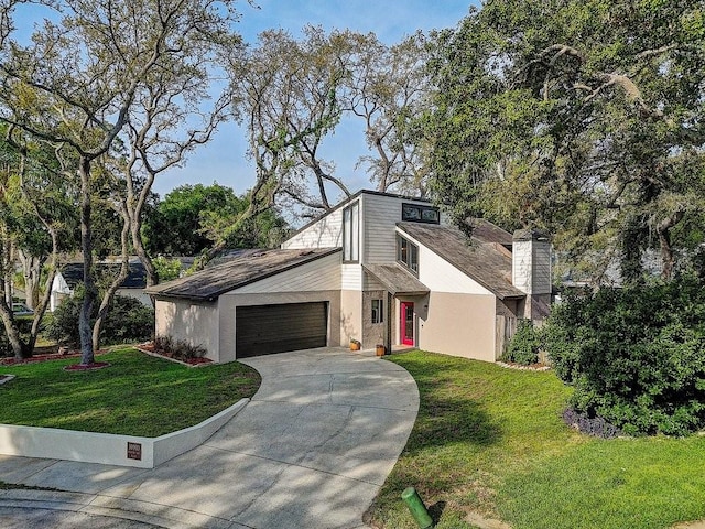 10910 Winter Oak Pl, Tampa, FL 33618 - mid-century home with driveway, a garage, a front yard, and stucco siding