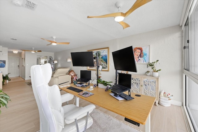 office with a ceiling fan, wood finished floors, and baseboards