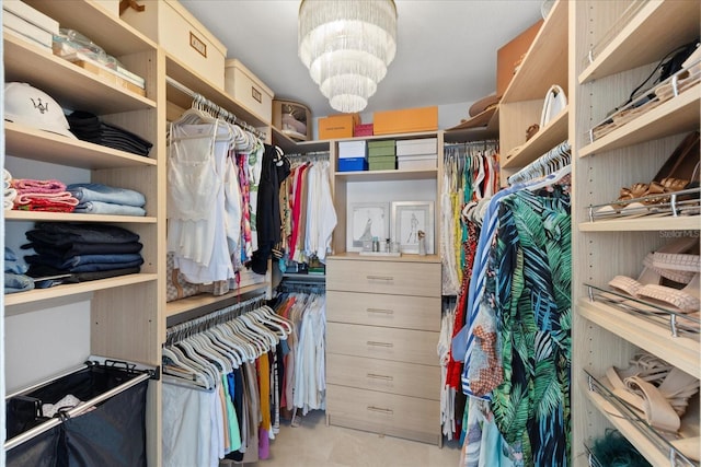 spacious closet featuring a chandelier
