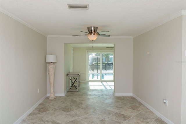 unfurnished room featuring crown molding, a ceiling fan, baseboards, and light stone finish floors