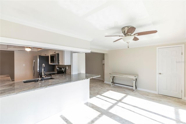 kitchen with appliances with stainless steel finishes, a ceiling fan, a peninsula, light stone countertops, and crown molding