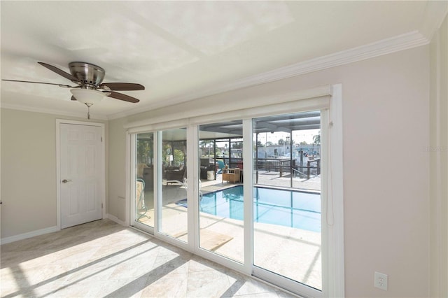 entryway featuring crown molding, plenty of natural light, baseboards, and ceiling fan
