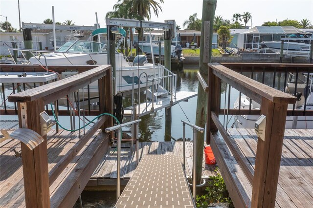 dock with boat lift and a water view