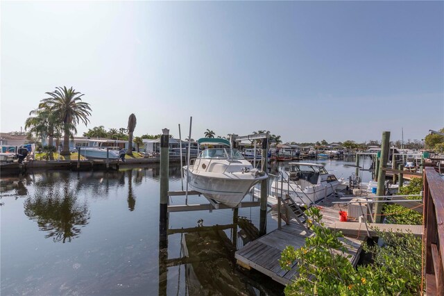 dock area featuring boat lift and a water view