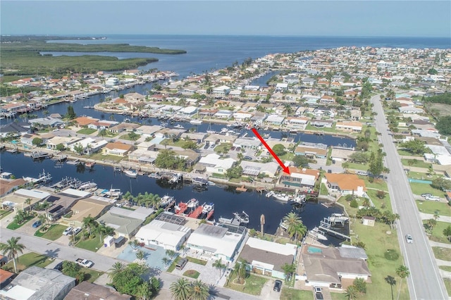 view of property location with a nearby body of water and nearby suburban area