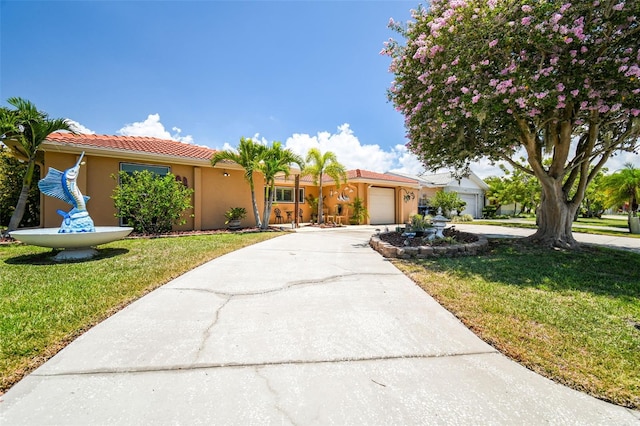 view of front of property featuring a front yard, a garage, stucco siding, concrete driveway, and a tile roof