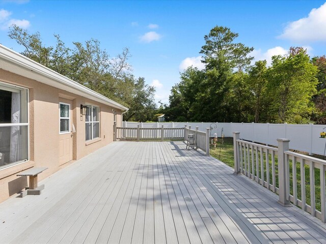wooden terrace featuring fence