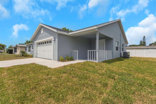 view of side of home with an attached garage, stucco siding, central air condition unit, and driveway
