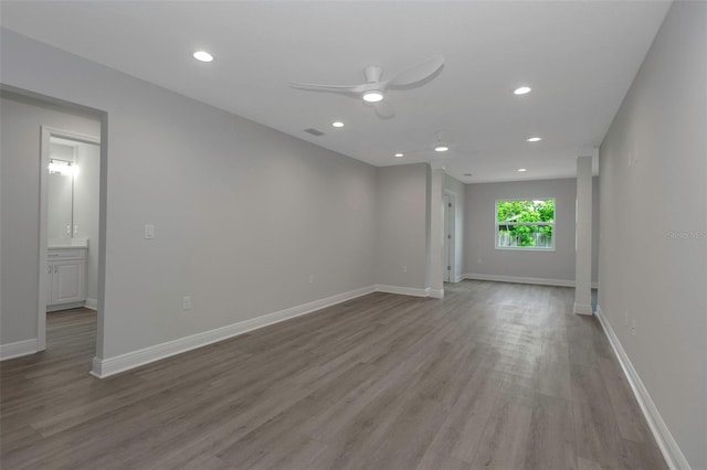 spare room featuring wood finished floors, ceiling fan, recessed lighting, and baseboards