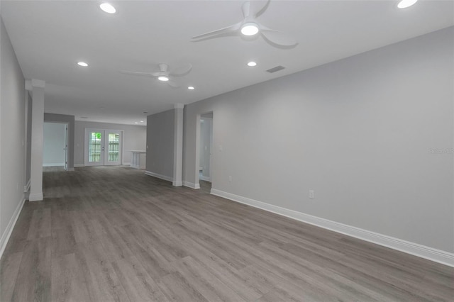 empty room featuring a ceiling fan, wood finished floors, recessed lighting, and baseboards
