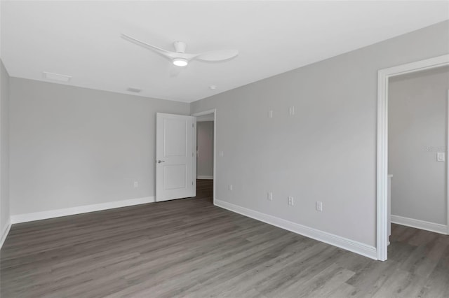 unfurnished room with wood finished floors, baseboards, and a ceiling fan