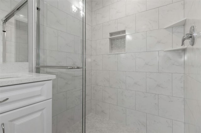 bathroom featuring a shower stall and vanity