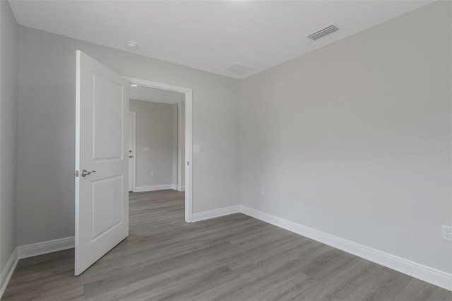 unfurnished room featuring wood finished floors and baseboards