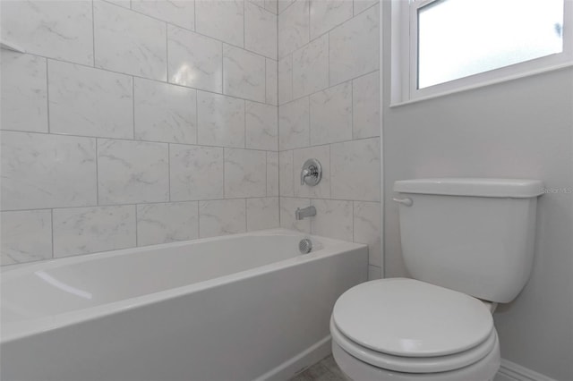 bathroom featuring toilet and baseboards