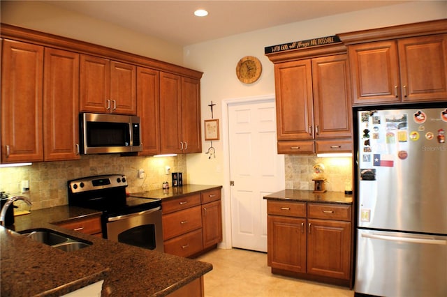 4837 Rainbow Race, New Port Richey, FL 34652 - kitchen with stainless steel appliances, a sink, tasteful backsplash, dark stone countertops, and recessed lighting