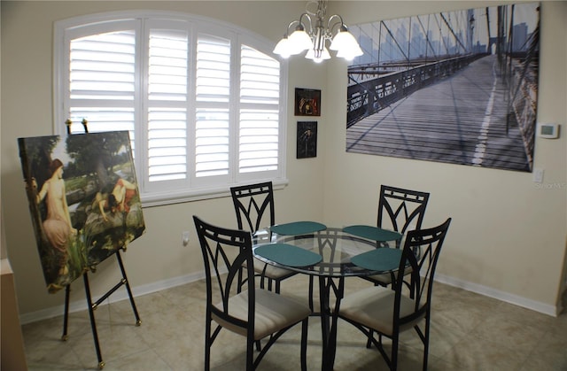 4837 Rainbow Race, New Port Richey, FL 34652 - dining area with a chandelier, tile patterned flooring, and baseboards