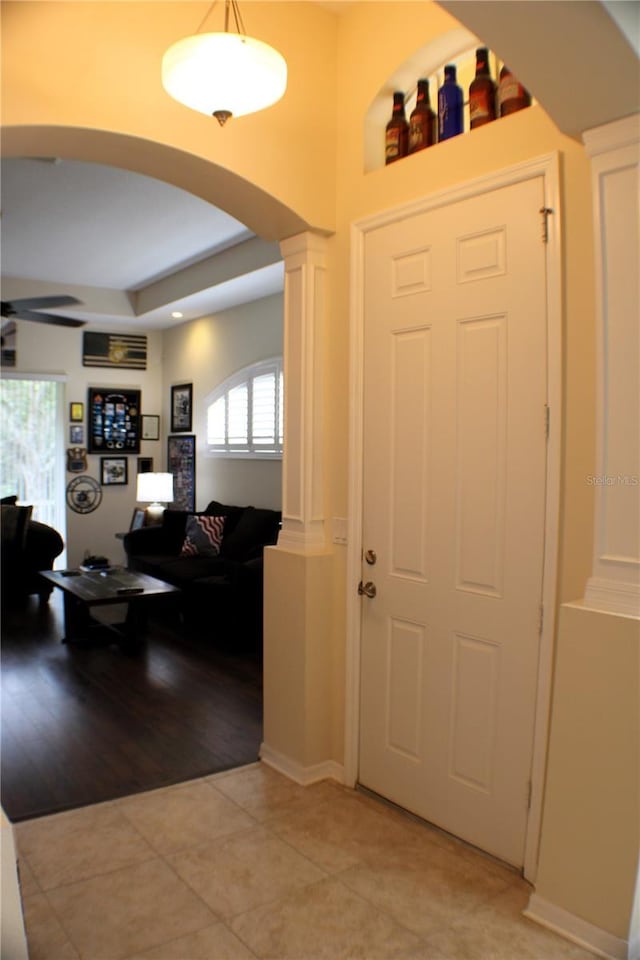 4837 Rainbow Race, New Port Richey, FL 34652 - entryway with arched walkways, decorative columns, light tile patterned flooring, and a tray ceiling