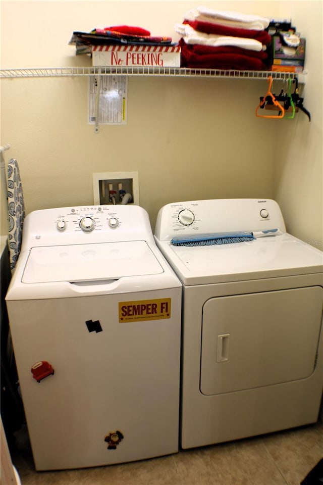 4837 Rainbow Race, New Port Richey, FL 34652 - washroom with washer and clothes dryer and light tile patterned floors