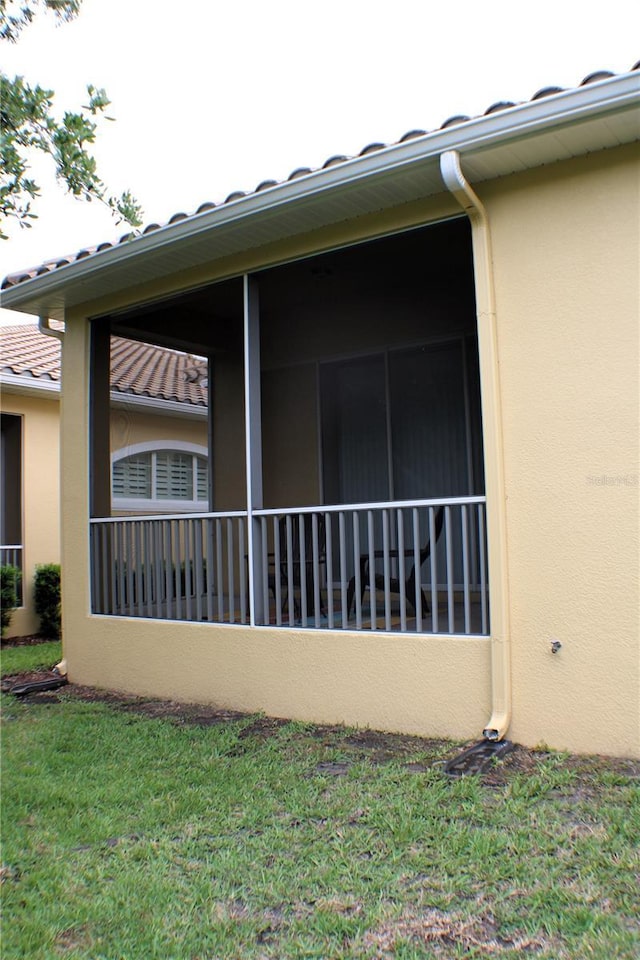 4837 Rainbow Race, New Port Richey, FL 34652 - view of property exterior with stucco siding, a tiled roof, and a yard
