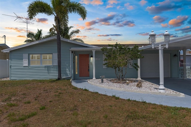 13411 Lisa Dr, Hudson, FL 34667 - single story home featuring a lawn, an attached garage, and driveway