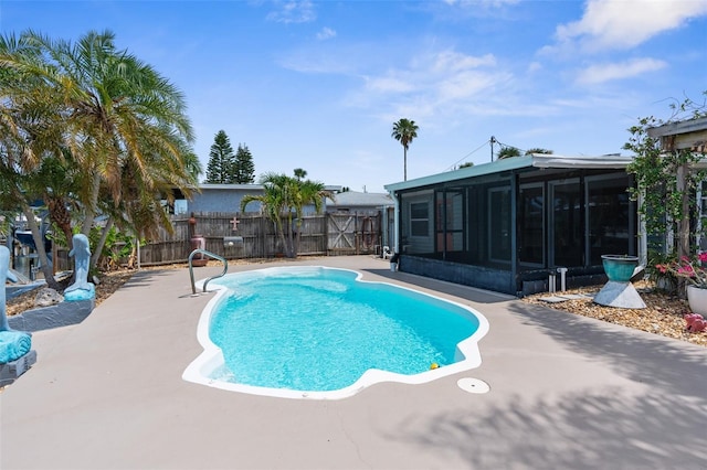13411 Lisa Dr, Hudson, FL 34667 - view of swimming pool with a sunroom, a fenced backyard, and a patio area