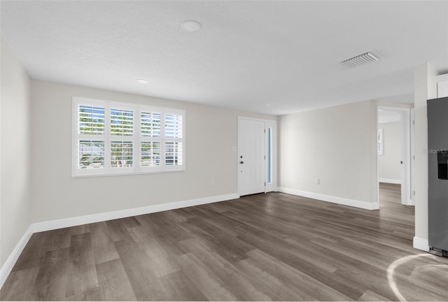 13411 Lisa Dr, Hudson, FL 34667 - unfurnished living room with dark wood-type flooring, baseboards, and recessed lighting