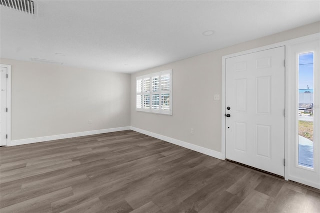 13411 Lisa Dr, Hudson, FL 34667 - foyer entrance with dark wood finished floors and baseboards