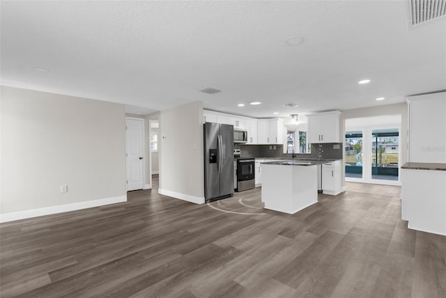 13411 Lisa Dr, Hudson, FL 34667 - kitchen featuring stainless steel appliances, open floor plan, dark wood-type flooring, a kitchen island, and recessed lighting