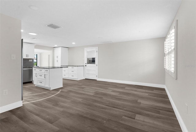 13411 Lisa Dr, Hudson, FL 34667 - unfurnished living room featuring baseboards, dark wood-style floors, and recessed lighting