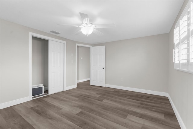 13411 Lisa Dr, Hudson, FL 34667 - unfurnished bedroom featuring wood finished floors, a closet, baseboards, and ceiling fan