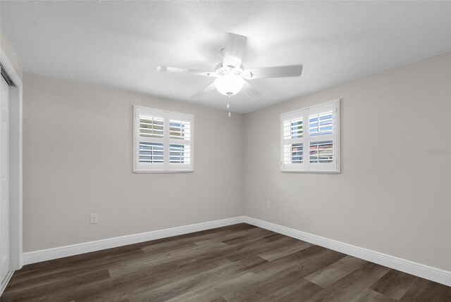13411 Lisa Dr, Hudson, FL 34667 - unfurnished room with plenty of natural light, dark wood-type flooring, a ceiling fan, and baseboards